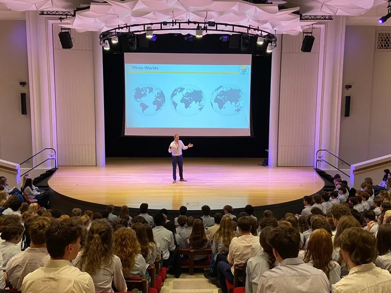 Patrick Foster speaking to a room of schoolchildren